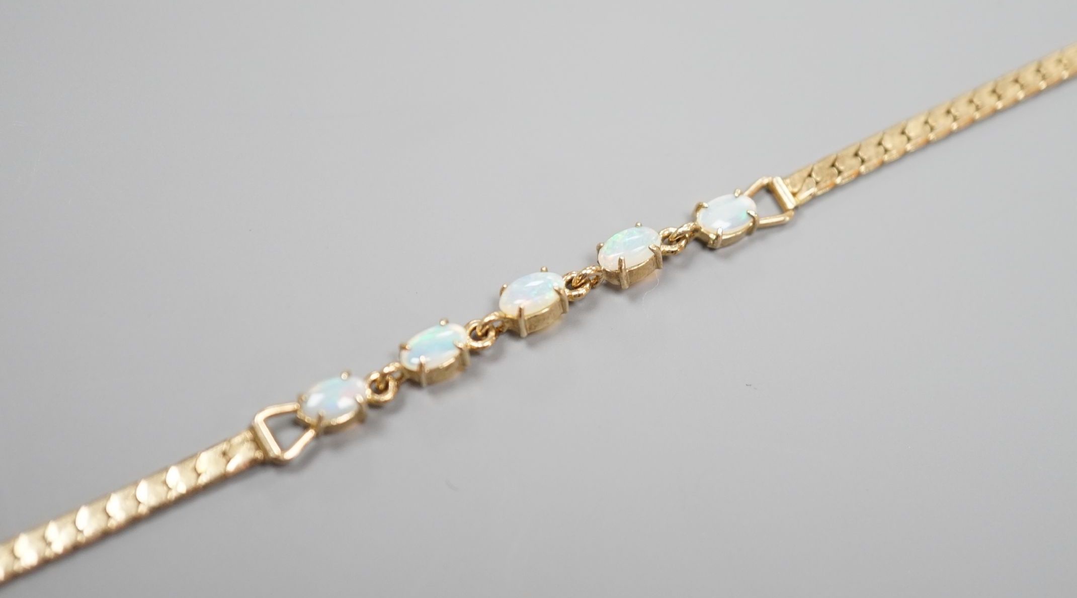 A modern gilt metal and five stone oval white opal set bracelet, 16.5cm.